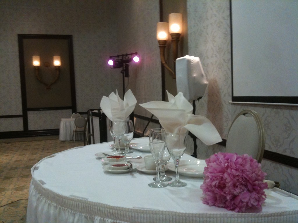 Sweetheart table with DJ booth in background